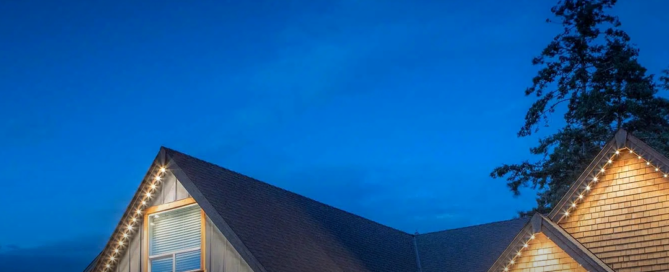 Warm white permanent outdoor lights along a home roofline at dusk — everyday architectural lighting, not holiday décor.