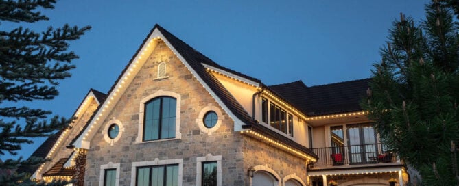 Warm white permanent Christmas lights on architectural stone — north-side Greater Cincinnati (Mason, Loveland, Maineville).