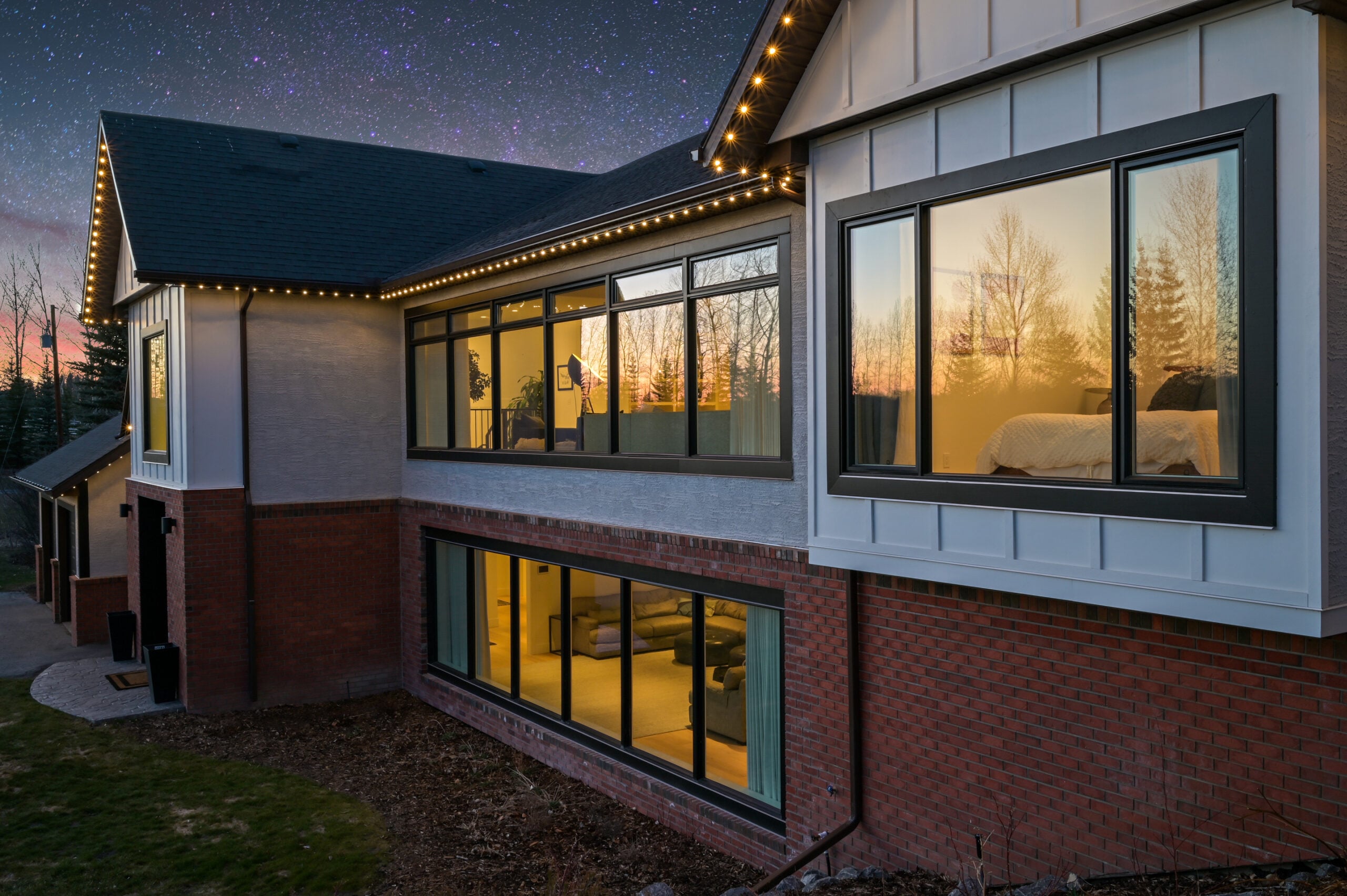A continuous warm white permanent lighting line along the eaves of a modern home at dusk — example from an authorized Gemstone dealer gallery.