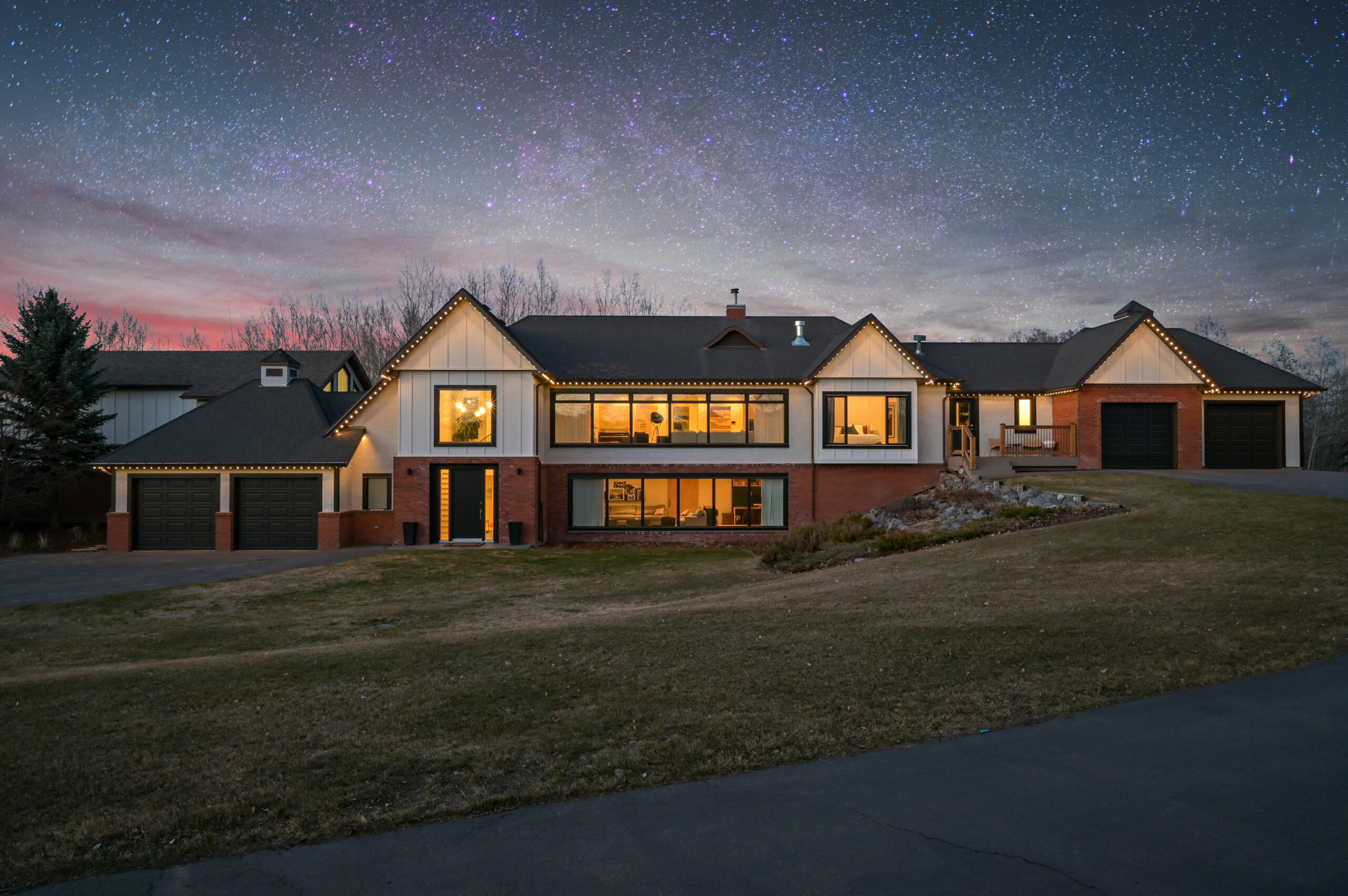 Whole-home warm white permanent lighting at dusk — everyday architectural use, shown as an authorized Gemstone dealer example.